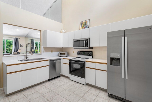 kitchen with white cabinetry, sink, and stainless steel appliances