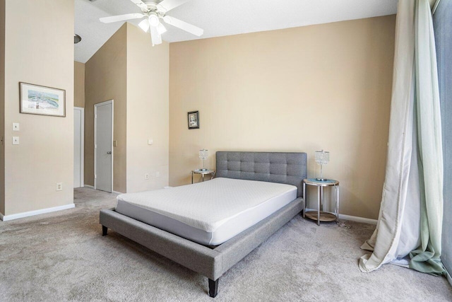 bedroom with ceiling fan, light carpet, and vaulted ceiling