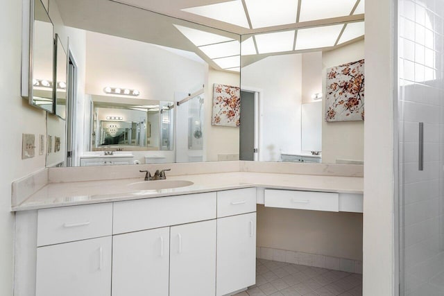 bathroom with tile patterned floors, vanity, and walk in shower