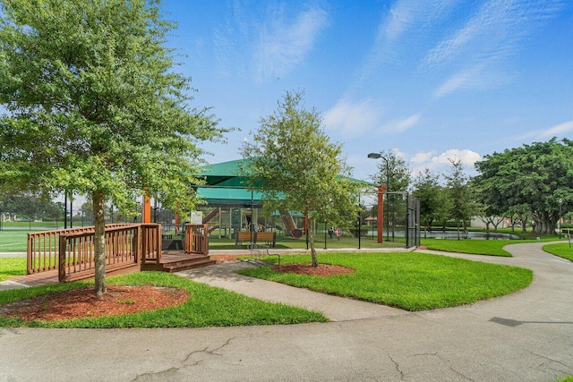 view of home's community featuring a lawn and a deck