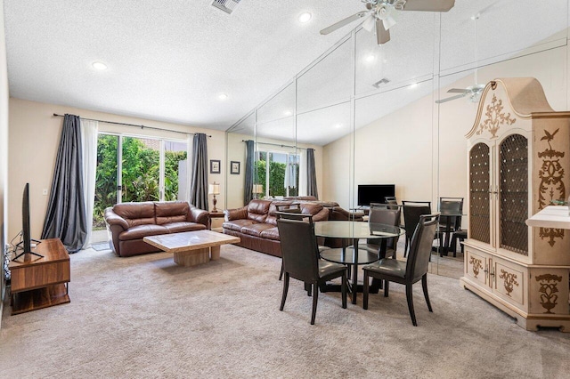 dining area featuring high vaulted ceiling, ceiling fan, a textured ceiling, and light carpet