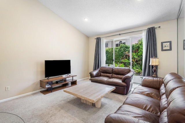 living room featuring a textured ceiling, light colored carpet, and lofted ceiling