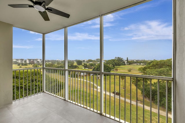 unfurnished sunroom with a healthy amount of sunlight and ceiling fan