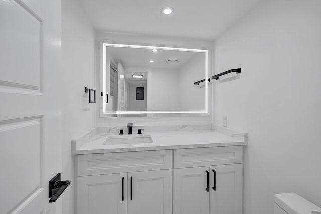 bathroom featuring vanity and toilet