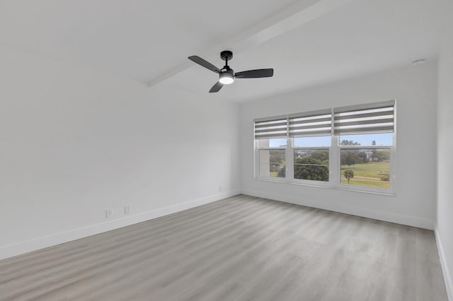 spare room featuring ceiling fan, light hardwood / wood-style flooring, and beamed ceiling