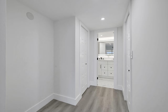 hallway with light hardwood / wood-style flooring