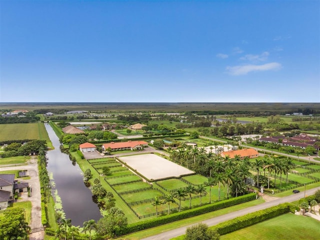 birds eye view of property featuring a rural view and a water view