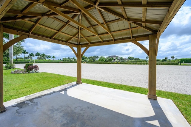 view of patio with a gazebo and a water view