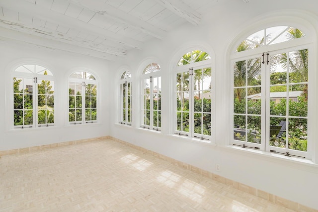 unfurnished sunroom featuring beam ceiling, wood ceiling, and french doors