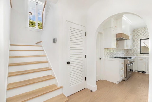 stairway with hardwood / wood-style floors