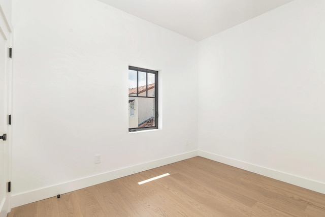 empty room with light hardwood / wood-style flooring