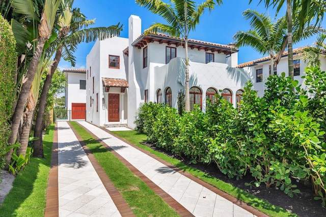 mediterranean / spanish house featuring a balcony