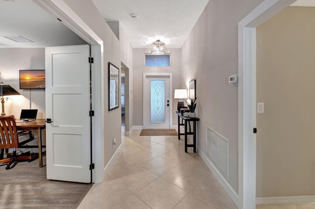 foyer entrance with light tile patterned floors