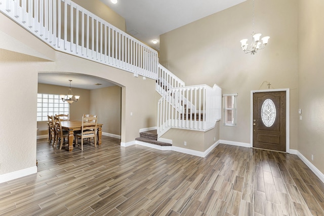 entryway featuring a high ceiling and an inviting chandelier