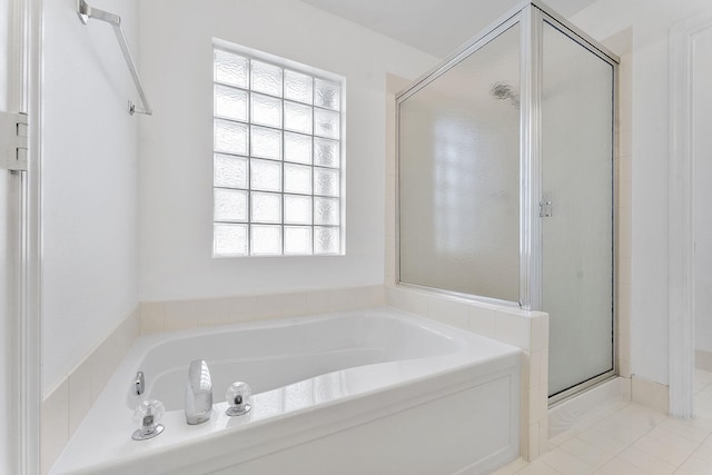 bathroom featuring separate shower and tub, tile patterned floors, and a healthy amount of sunlight