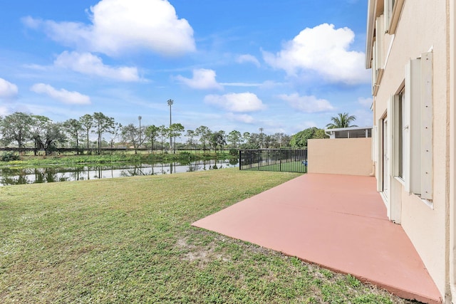 view of yard featuring a patio area and a water view