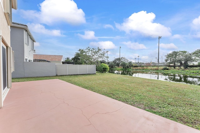 view of yard featuring a water view and a patio