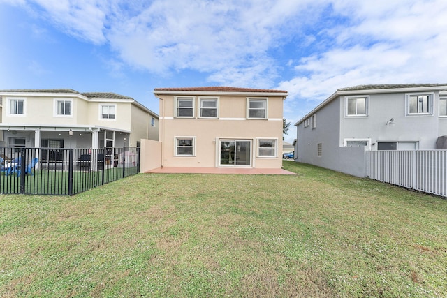 rear view of property featuring a patio area and a yard