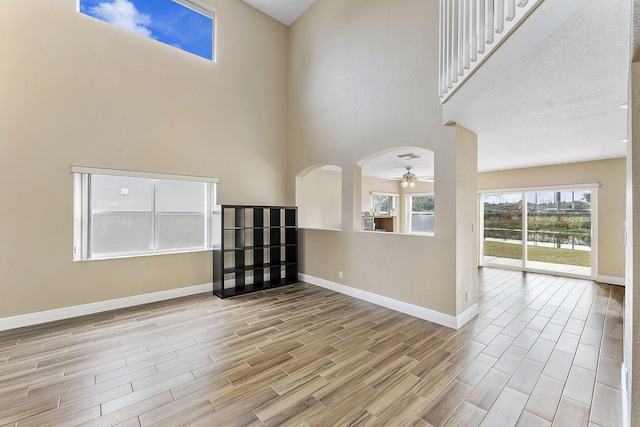 spare room with ceiling fan and a towering ceiling