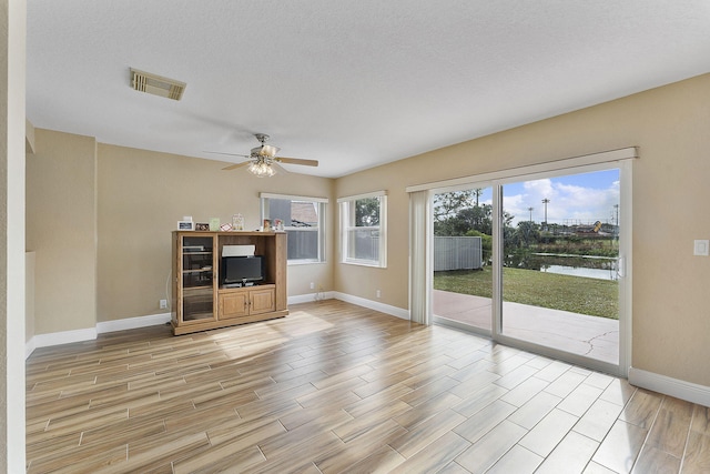 unfurnished living room featuring ceiling fan