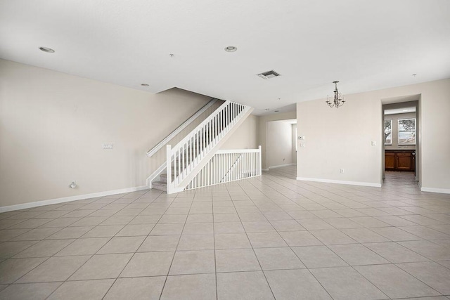 unfurnished living room featuring light tile patterned floors and an inviting chandelier