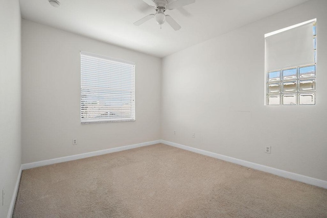 empty room featuring light carpet and ceiling fan