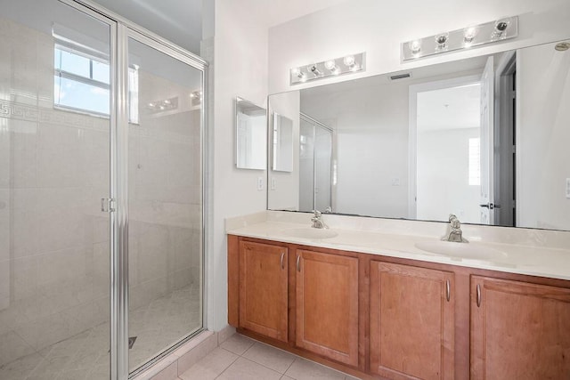 bathroom with tile patterned flooring, vanity, and an enclosed shower