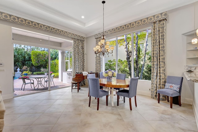 tiled dining area with a notable chandelier, crown molding, and a tray ceiling