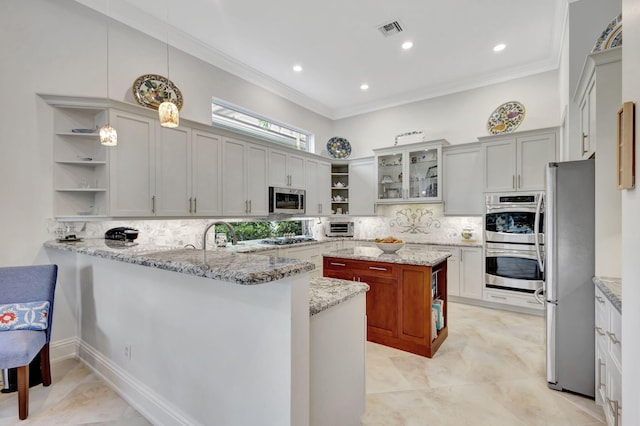 kitchen with kitchen peninsula, decorative backsplash, light stone counters, stainless steel appliances, and decorative light fixtures