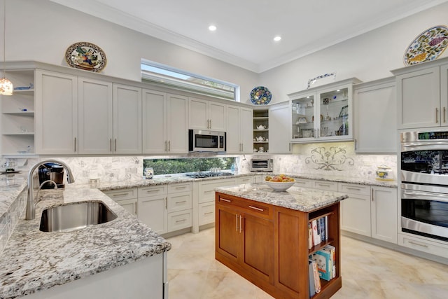 kitchen with sink, light stone countertops, appliances with stainless steel finishes, tasteful backsplash, and white cabinetry