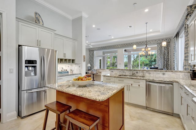 kitchen featuring white cabinets, appliances with stainless steel finishes, decorative backsplash, and sink