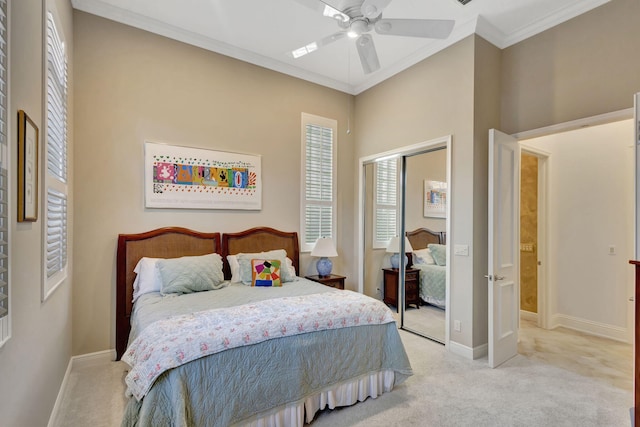 bedroom featuring light carpet, a closet, ceiling fan, and crown molding