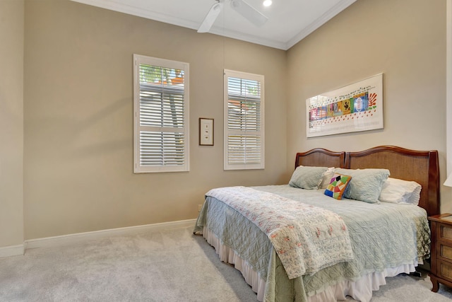 bedroom featuring light carpet, ceiling fan, and crown molding