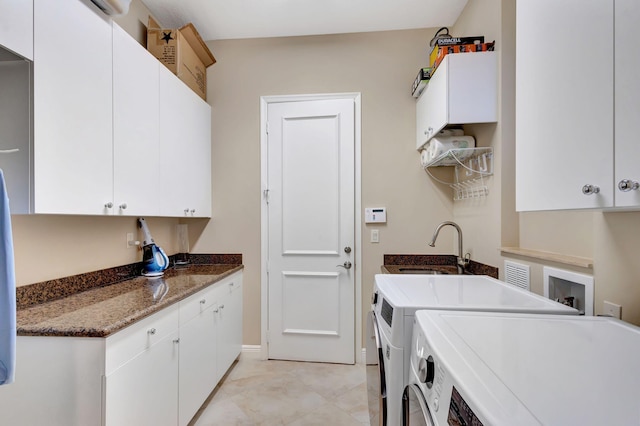 laundry area with cabinets, independent washer and dryer, and sink