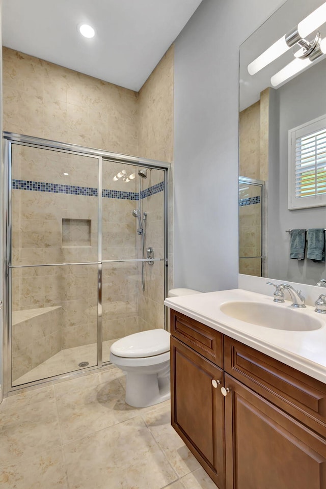 bathroom with vanity, toilet, and walk in shower