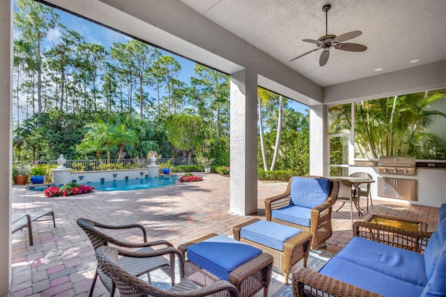 view of patio / terrace featuring a fenced in pool, area for grilling, and ceiling fan