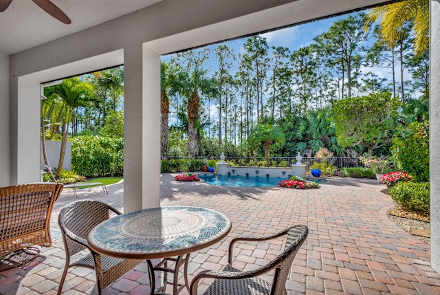 view of patio with a fenced in pool and ceiling fan