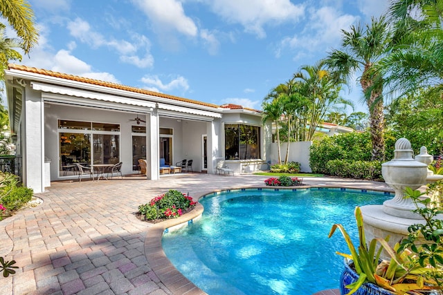 view of pool with ceiling fan and a patio area