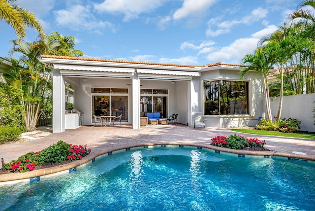 view of swimming pool with a patio area and ceiling fan