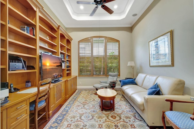 interior space featuring ceiling fan, ornamental molding, and a tray ceiling