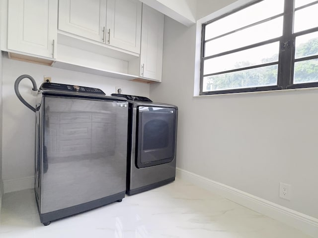 laundry room featuring cabinets and separate washer and dryer