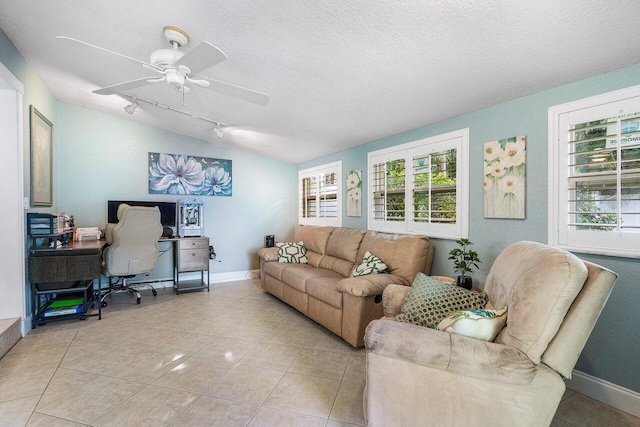 tiled living room featuring a textured ceiling, ceiling fan, and vaulted ceiling