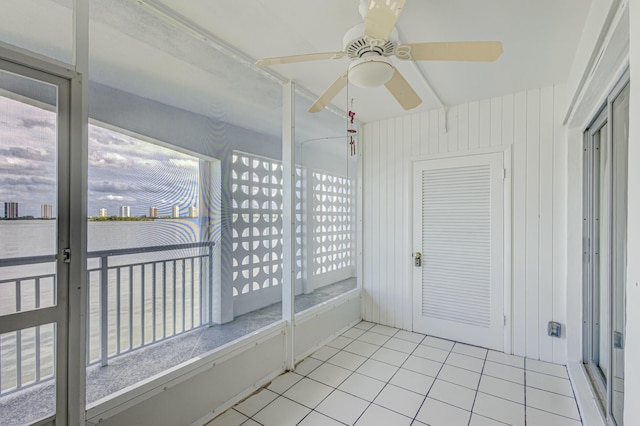 unfurnished sunroom with ceiling fan