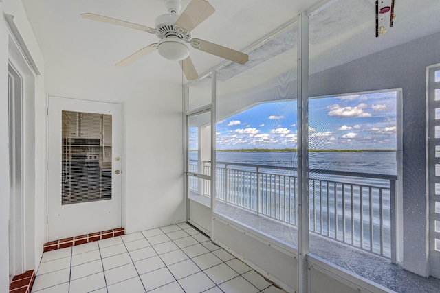 unfurnished sunroom with ceiling fan