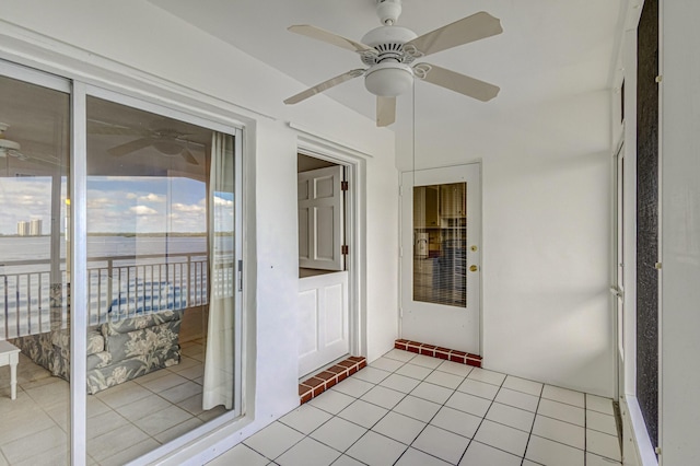 unfurnished sunroom featuring ceiling fan