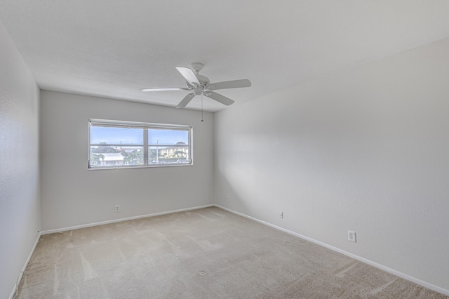 unfurnished room featuring light carpet and ceiling fan