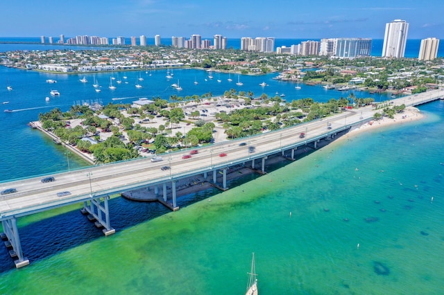 drone / aerial view with a water view and a beach view