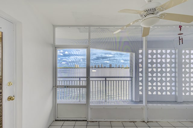 unfurnished sunroom featuring ceiling fan