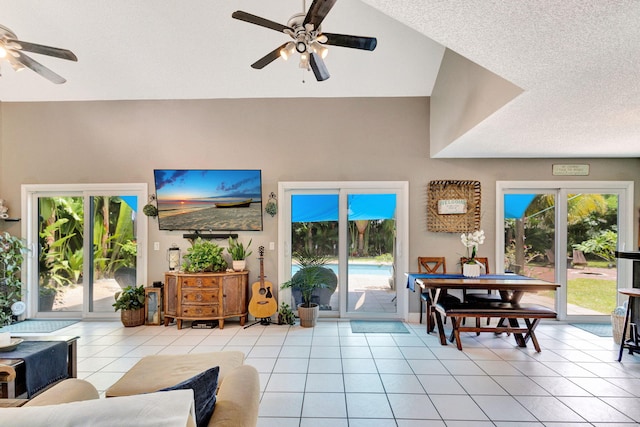 tiled living room featuring ceiling fan and a textured ceiling