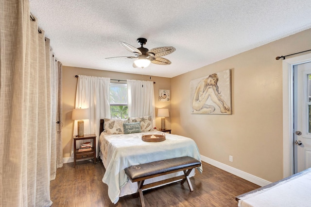 bedroom featuring ceiling fan, dark wood-type flooring, and a textured ceiling